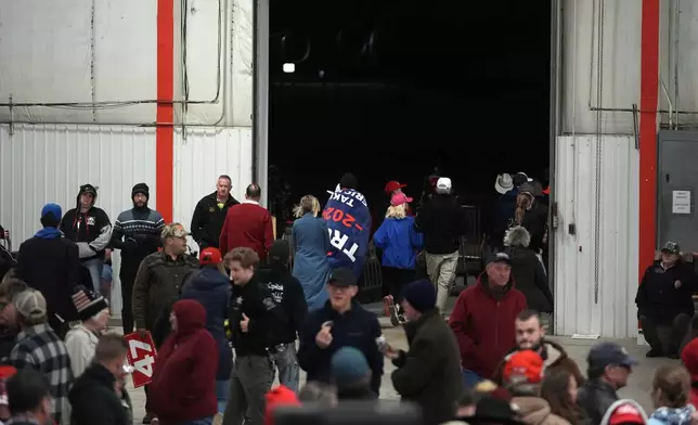 Attendees leave a campaign event for Republican presidential nominee former President Donald Trump before he arrives Friday, Oct. 25, 2024, in Traverse City, Mich. (AP Photo/Paul Sancya)