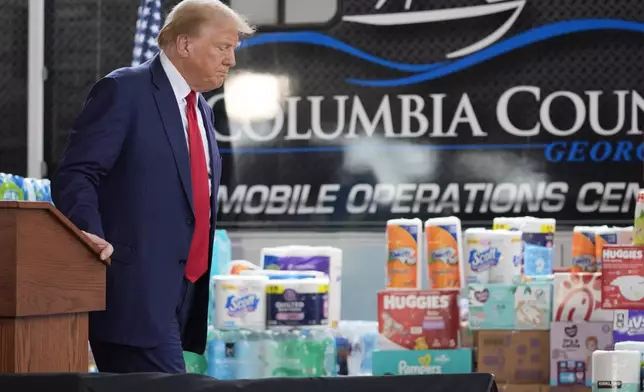 Republican presidential nominee former President Donald Trump walks from the podium after speaking at a temporary relief shelter as he visits areas impacted by Hurricane Helene, Friday, Oct. 4, 2024, in Evans, Ga. (AP Photo/Evan Vucci)