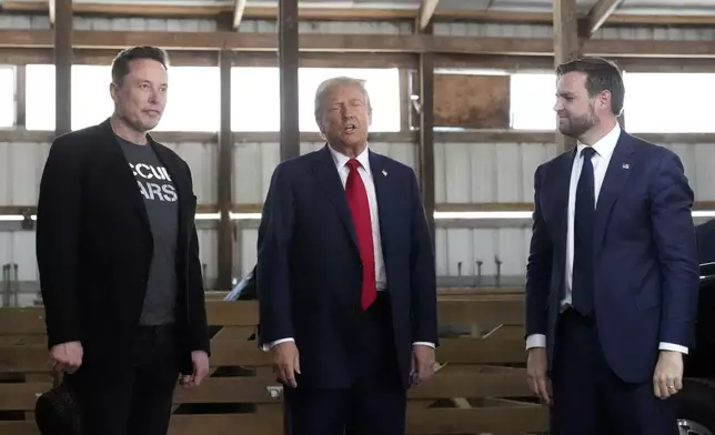 Tesla and SpaceX CEO Elon Musk, from left, Republican presidential nominee former President Donald Trump and Republican vice presidential nominee Sen. JD Vance, R-Ohio, attend a campaign event at the Butler Farm Show, Saturday, Oct. 5, 2024, in Butler, Pa. (AP Photo/Alex Brandon)