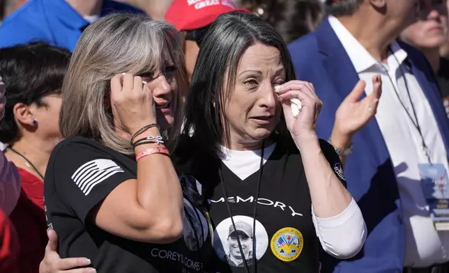 Kelly Comperatore-Meeder, left, and Dawn Comperatore-Schafer, sisters of firefighter Corey Comperatore, who died as he shielded family members from gunfire, cry at a campaign event for Republican presidential nominee former President Donald Trump, at the Butler Farm Show, the site where a gunman tried to assassinate Trump in July, Saturday, Oct. 5, 2024, in Butler, Pa. (AP Photo/Alex Brandon)