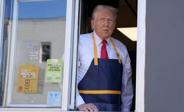 Republican presidential nominee former President Donald Trump stands at the drive-thru window during a campaign stop at a McDonald's, Sunday, Oct. 20, 2024, in Feasterville-Trevose, Pa. (AP Photo/Evan Vucci)