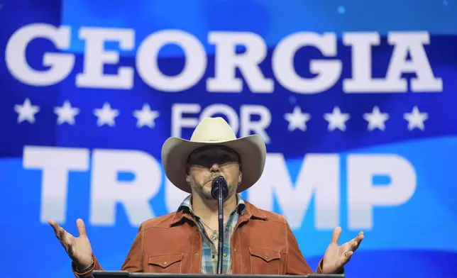 Jason Aldean speaks before Republican presidential nominee former President Donald Trump at a Turning Point Action campaign rally, Wednesday, Oct. 23, 2024, in Duluth, Ga. (AP Photo/Alex Brandon)