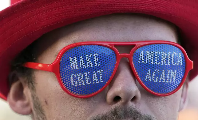 A supporter of Republican presidential nominee former President Donald Trump waits in line to enter a campaign rally at the Butler Farm Show, Saturday, Oct. 5, 2024, in Butler, Pa. (AP Photo/Julia Demaree Nikhinson)