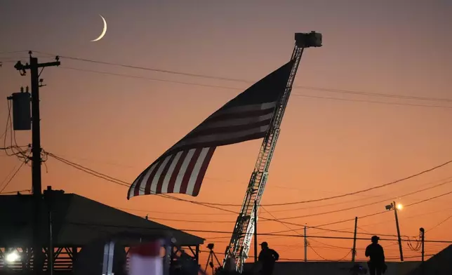 A flag waves as Republican presidential nominee former President Donald Trump speaks at a campaign event at the Butler Farm Show, Saturday, Oct. 5, 2024, in Butler, Pa. (AP Photo/Alex Brandon)