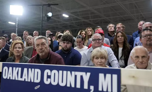 Supporters listen as Republican presidential nominee former President Donald Trump speaks at a campaign roundtable, Friday, Oct. 18, 2024, in Auburn Hills, Mich. (AP Photo/Evan Vucci)