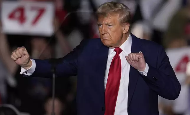 Republican presidential nominee former President Donald Trump dances at a campaign rally at McCamish Pavilion Monday, Oct. 28, 2024, in Atlanta. (AP Photo/Mike Stewart)