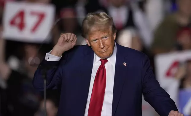 Republican presidential nominee former President Donald Trump dances at a campaign rally at McCamish Pavilion Monday, Oct. 28, 2024, in Atlanta. (AP Photo/Mike Stewart)