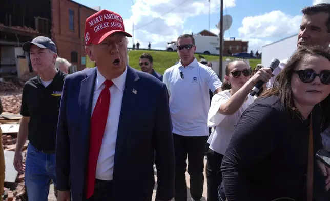 Republican presidential nominee former President Donald Trump walks outside the Chez What furniture store as he visits Valdosta, Ga., a town impacted by Hurricane Helene, Monday, Sept. 30, 2024. (AP Photo/Evan Vucci)