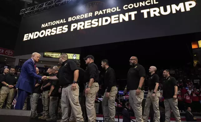 Republican presidential nominee former President Donald Trump greets members of the U.S. Border Patrol as he speaks at a campaign rally at the Findlay Toyota Arena Sunday, Oct. 13, 2024, in Prescott Valley, Ariz. (AP Photo/Evan Vucci)