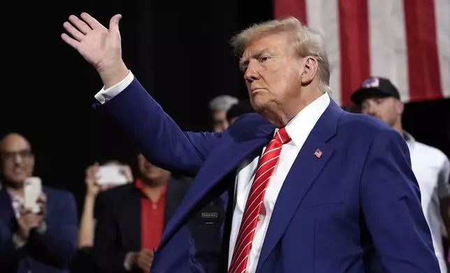 Republican presidential nominee former President Donald Trump waves at a campaign event at the Cobb Energy Performing Arts Centre, Tuesday, Oct. 15, 2024, in Atlanta. (AP Photo/Alex Brandon)