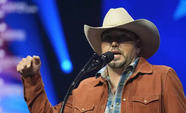 Jason Aldean speaks before Republican presidential nominee former President Donald Trump at a Turning Point Action campaign rally, Wednesday, Oct. 23, 2024, in Duluth, Ga. (AP Photo/Alex Brandon)