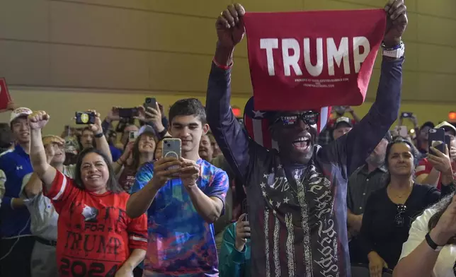 Supporters listen as Republican presidential nominee former President Donald Trump speaks at a town hall at Lancaster County Convention Center, Sunday, Oct. 20, 2024, in Lancaster, Pa. (AP Photo/Evan Vucci)