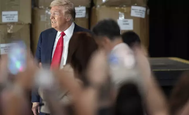 Republican presidential nominee former President Donald Trump arrives to speak at a campaign event at Beauty Society, Saturday, Oct. 12, 2024, in North Las Vegas, Nev. (AP Photo/John Locher)