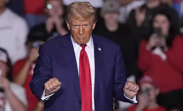 Republican presidential nominee former President Donald Trump dances at a campaign event at the Ryder Center at Saginaw Valley State University, Thursday, Oct. 3, 2024, in University Center, Mich. (AP Photo/Carlos Osorio)