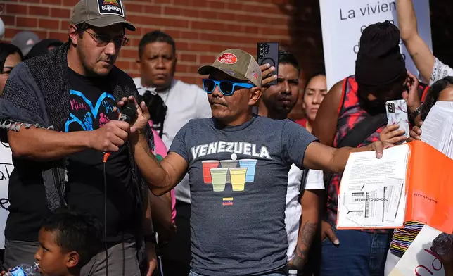 FILE - Moises Didenot speaks during a rally by the East Colfax Community Collective to address chronic problems in the apartment buildings occupied by people displaced from their home countries in central and South America, Sept. 3, 2024, in Aurora, Colo. (AP Photo/David Zalubowski, File)