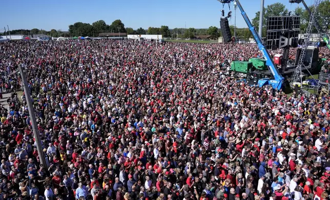 Attendees listen during the singing of the national anthem before Republican presidential nominee former President Donald Trump arrives to speak at a campaign event at the Butler Farm Show, Saturday, Oct. 5, 2024, in Butler, Pa. (AP Photo/Alex Brandon)