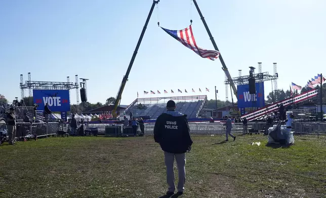 A U.S. Secret Service agent looks at the site before Republican presidential nominee former President Donald Trump speaks at a campaign rally at the Butler Farm Show, the site where a gunman tried to assassinate him in July, Saturday, Oct. 5, 2024, in Butler, Pa. (AP Photo/Alex Brandon)