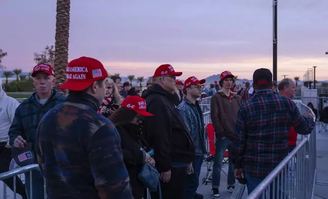 People wait in line for a campaign rally for Republican presidential nominee former President Donald Trump at Lee's Family Forum, Thursday, Oct. 31, 2024, in Henderson, Nev. (AP Photo/Evan Vucci)