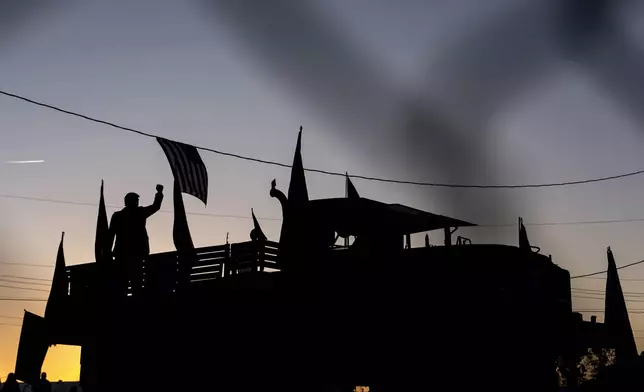 A statue of Republican presidential nominee former President Donald Trump is set up on a track before a campaign rally at the Butler Farm Show, Saturday, Oct. 5, 2024, in Butler, Pa. (AP Photo/Julia Demaree Nikhinson)