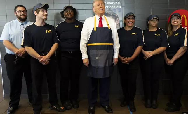 Republican presidential nominee former President Donald Trump poses with employees during a campaign stop at a McDonald's in Feasterville-Trevose, Pa., Sunday, Oct. 20, 2024. (Doug Mills/The New York Times via AP, Pool)