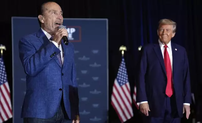 Republican presidential nominee former President Donald Trump listens to Lee Greenwood sing at a faith event at the Concord Convention Center, Monday, Oct. 21, 2024, in Concord, N.C. (AP Photo/Evan Vucci)