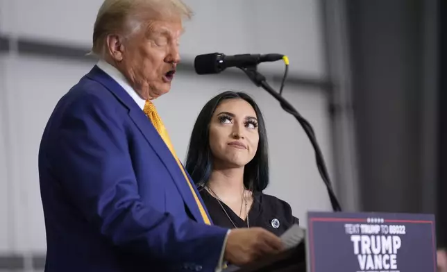 Republican presidential nominee former President Donald Trump speaks as Alexis Nungaray, mother of the late Jocelyn Nungaray, listens during a news conference at Austin-Bergstrom International Airport, Friday, Oct. 25, 2024, in Austin, Texas. (AP Photo/Alex Brandon)