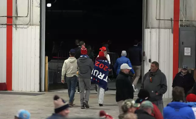 Attendees leave a campaign event for Republican presidential nominee former President Donald Trump before he arrives Friday, Oct. 25, 2024, in Traverse City, Mich. (AP Photo/Paul Sancya)