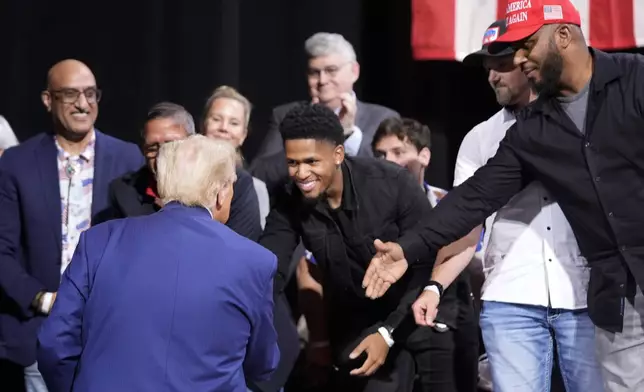 Republican presidential nominee former President Donald Trump greets supporters at a campaign event at the Cobb Energy Performing Arts Centre, Tuesday, Oct. 15, 2024, in Atlanta. (AP Photo/Alex Brandon)