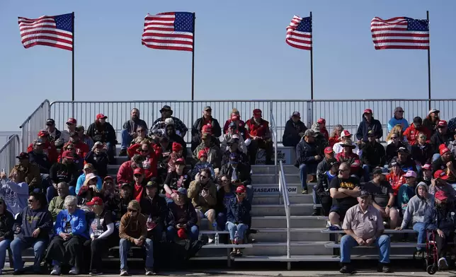 People wait for Republican presidential nominee former President Donald Trump to speak during a campaign rally at Dodge County Airport, Sunday, Oct. 6, 2024, in Juneau, Wis. (AP Photo/Julia Demaree Nikhinson)