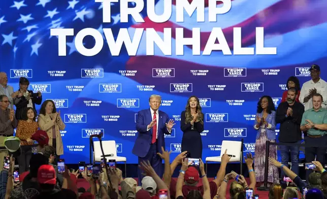 Republican presidential nominee former President Donald Trump gestures at a campaign town hall at the Greater Philadelphia Expo Center &amp; Fairgrounds, Monday, Oct. 14, 2024, in Oaks, Pa., as moderator South Dakota Gov. Kristi Noem watches. (AP Photo/Matt Rourke)