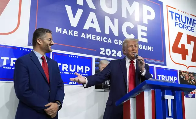 Republican presidential nominee former President Donald Trump speaks as Hamtramck Mayor Amer Ghalib listens at a campaign office, Friday, Oct. 18, 2024, in Hamtramck, Mich. (AP Photo/Evan Vucci)