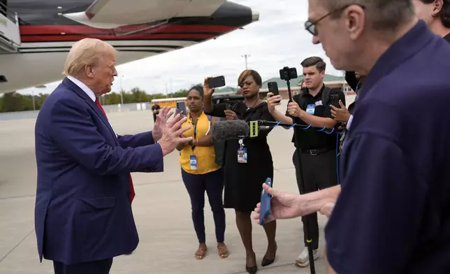 Republican presidential nominee former President Donald Trump speaks with reporters as he arrives at Augusta Regional Airport to visit areas impacted by Hurricane Helene, Friday, Oct. 4, 2024, in Augusta, Ga. (AP Photo/Evan Vucci)