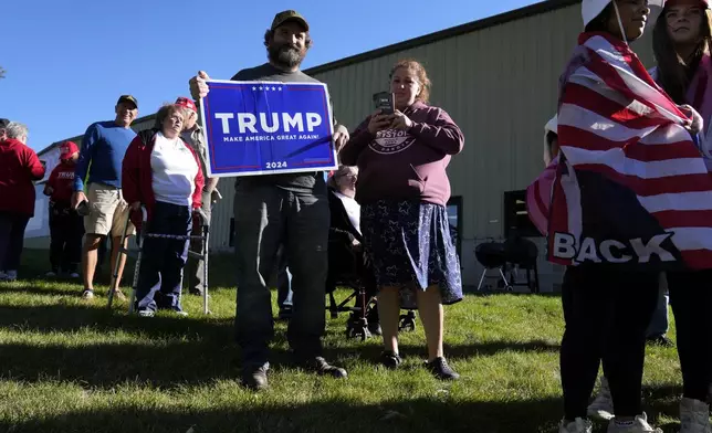 Jeff Norton, of Monroe, Wis., waits to enter a Republican presidential nominee former President Donald Trump campaign event at Dane Manufacturing, Tuesday, Oct. 1, 2024, in Waunakee, Wis. (AP Photo/Charlie Neibergall)