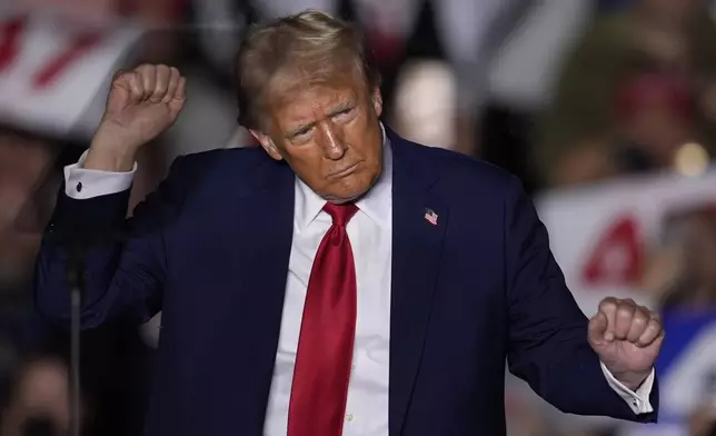 Republican presidential nominee former President Donald Trump dances at a campaign rally at McCamish Pavilion Monday, Oct. 28, 2024, in Atlanta. (AP Photo/Mike Stewart)