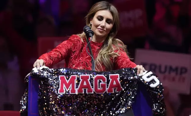 Alina Habba puts a jacket on the podium as she speaks before Republican presidential nominee former President Donald Trump speaks at a campaign rally at Madison Square Garden, Sunday, Oct. 27, 2024, in New York. (AP Photo/Evan Vucci)