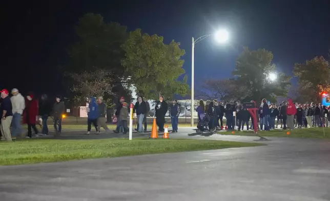 Supporters are seen leaving a campaign rally ahead of the arrival of Republican presidential nominee former President Donald Trump at Cherry Capital Airport, Friday, Oct. 25, 2024, in Traverse City, Mich. (AP Photo/Alex Brandon)