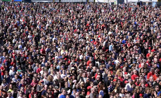 Attendees stand during the Pledge of Allegiance before Republican presidential nominee former President Donald Trump arrives to speak at a campaign event at the Butler Farm Show, Saturday, Oct. 5, 2024, in Butler, Pa. (AP Photo/Alex Brandon)