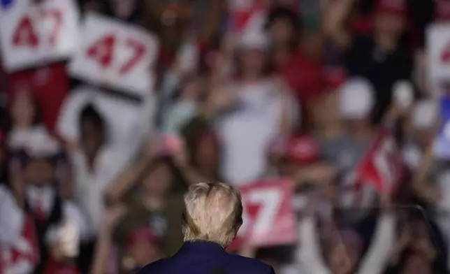 Republican presidential nominee former President Donald Trump turns to look at supporters as he speaks at a campaign rally at McCamish Pavilion Monday, Oct. 28, 2024, in Atlanta. (AP Photo/Mike Stewart)