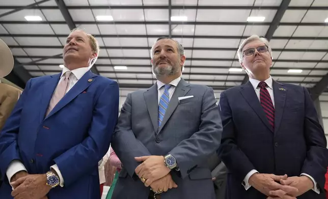 Sen. Ted Cruz, R-Texas, center, listens as Republican presidential nominee former President Donald Trump speaks during a news conference at Austin-Bergstrom International Airport, Friday, Oct. 25, 2024, in Austin, Texas. (AP Photo/Alex Brandon)