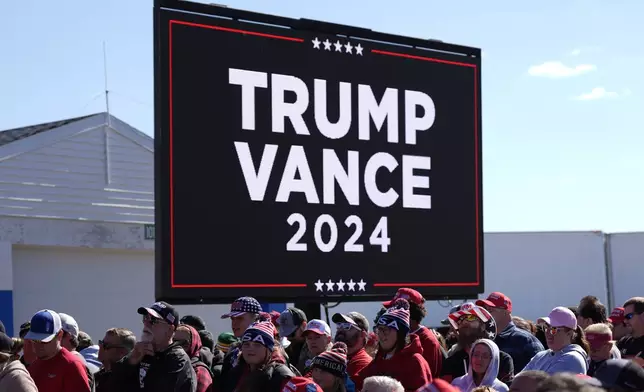 People wait for Republican presidential nominee former President Donald Trump to speak during a campaign rally at Dodge County Airport, Sunday, Oct. 6, 2024, in Juneau, Wis. (AP Photo/Julia Demaree Nikhinson)