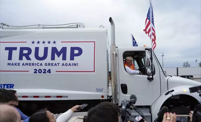 Republican presidential nominee former President Donald Trump talks to reporters as he sits in a garbage truck Wednesday, Oct. 30, 2024, in Green Bay, Wis. (AP Photo/Julia Demaree Nikhinson)