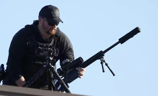 A member of the U.S. Secret Service counter sniper team sets up before Republican presidential nominee former President Donald Trump speaks at a campaign rally, Saturday, Oct. 19, 2024, at Arnold Palmer Regional Airport in Latrobe, Pa. (AP Photo/Matt Rourke)