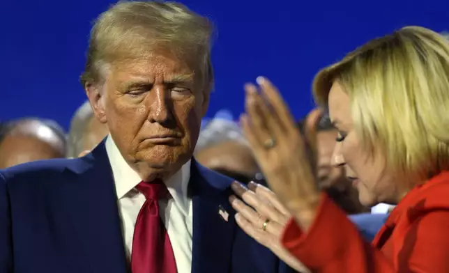 Republican presidential nominee former President Donald Trump closes his eyes as Pastor Paula White and other faith leaders pray over him, during the National Faith Summit at Worship With Wonders Church, Monday, Oct. 28, 2024, in Powder Springs, Ga. (AP Photo/Julia Demaree Nikhinson)