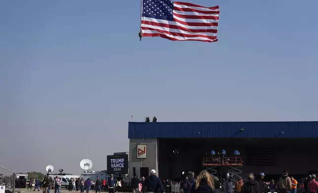 Attendees arrive at a campaign rally for Republican presidential nominee former President Donald Trump at Dodge County Airport, Sunday, Oct. 6, 2024, in Juneau, Wis. (AP Photo/Julia Demaree Nikhinson)