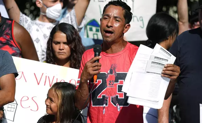 FILE - Juan Carlos Jimenez speaks during a rally by the East Colfax Community Collective to address chronic problems in the apartment buildings occupied by people displaced from their home countries in central and South America Sept. 3, 2024, in Aurora, Colo. (AP Photo/David Zalubowski, File)