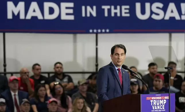 Former Wisconsin Gov. Scott Walker arrives before Republican presidential nominee former President Donald Trump at a campaign event at Dane Manufacturing, Tuesday, Oct. 1, 2024, in Waunakee, Wis. (AP Photo/Charlie Neibergall)