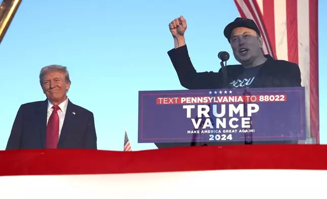 Tesla and SpaceX CEO Elon Musk speaks as Republican presidential nominee former President Donald Trump listens at a campaign event at the Butler Farm Show, Saturday, Oct. 5, 2024, in Butler, Pa. (AP Photo/Alex Brandon)