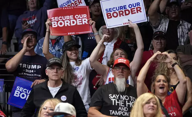 Supports react as Republican presidential nominee former President Donald Trump speaks at a campaign rally at the Findlay Toyota Arena Sunday, Oct. 13, 2024, in Prescott Valley, Ariz. (AP Photo/Evan Vucci)