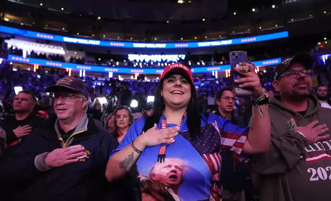 Attendees hold their hands over their hearts at a campaign rally for Republican presidential nominee former President Donald Trump at Madison Square Garden, Sunday, Oct. 27, 2024, in New York. (AP Photo/Julia Demaree Nikhinson)