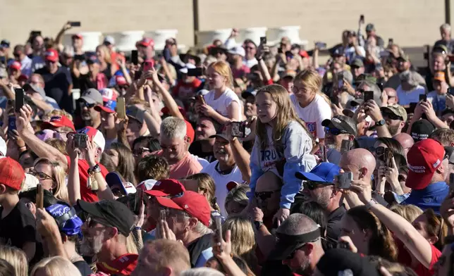 People listen as Republican presidential nominee former President Donald Trump speaks to an overflow crowd after a faith town hall at Christ Chapel Zebulon, Wednesday, Oct. 23, 2024, in Zebulon, Ga. (AP Photo/Alex Brandon)